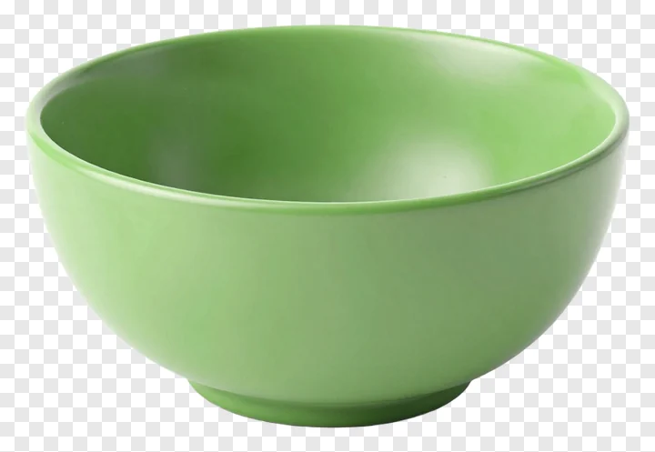 A green ceramic bowl on a white surface.