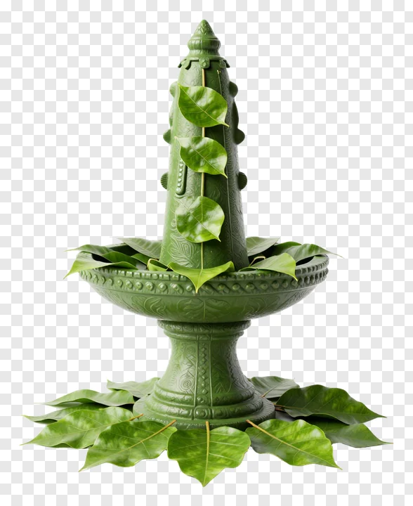A green ceramic lingam surrounded by bel leaves.