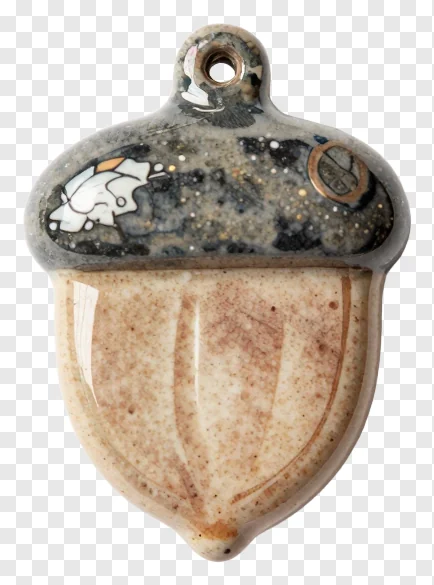 Hand-thrown clay acorn charm with speckled glaze.