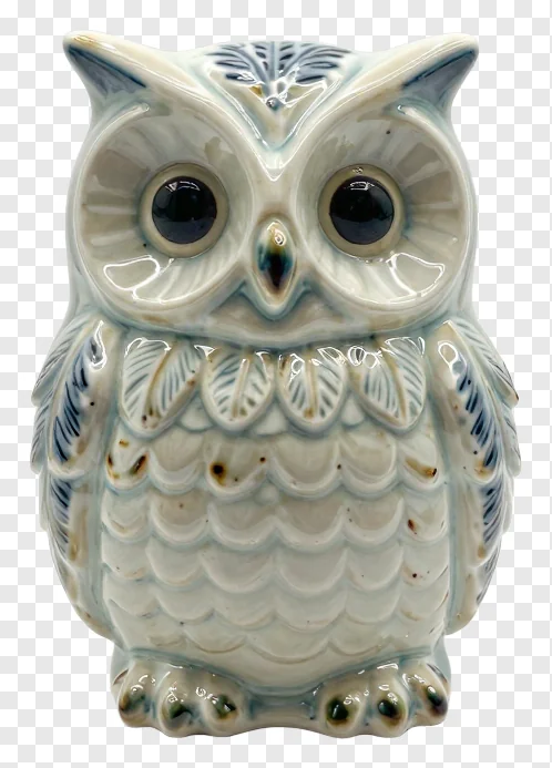 Ceramic owl with feathered collar design.