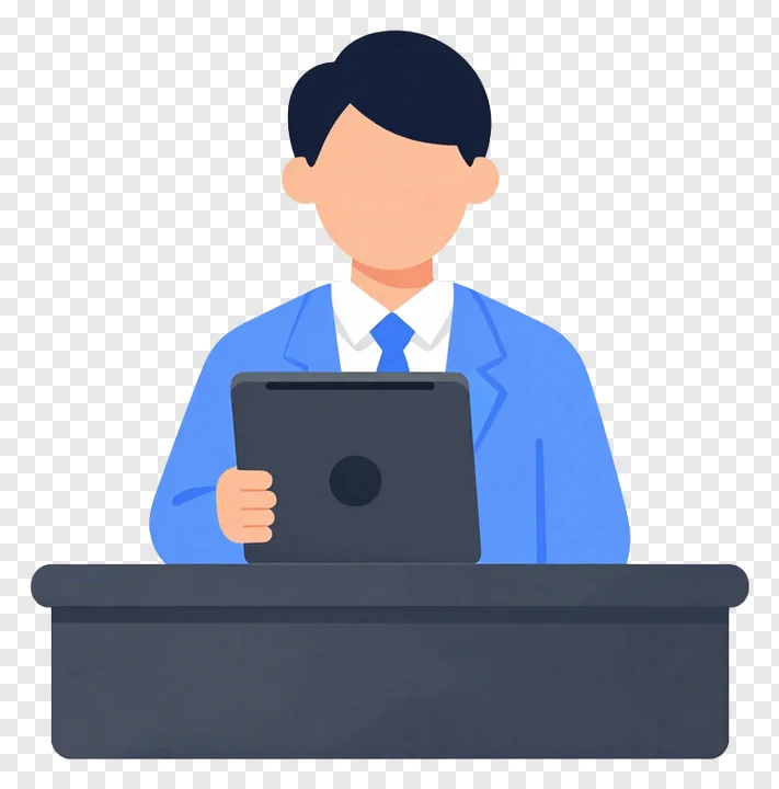 Individual working on laptop while seated at office desk.