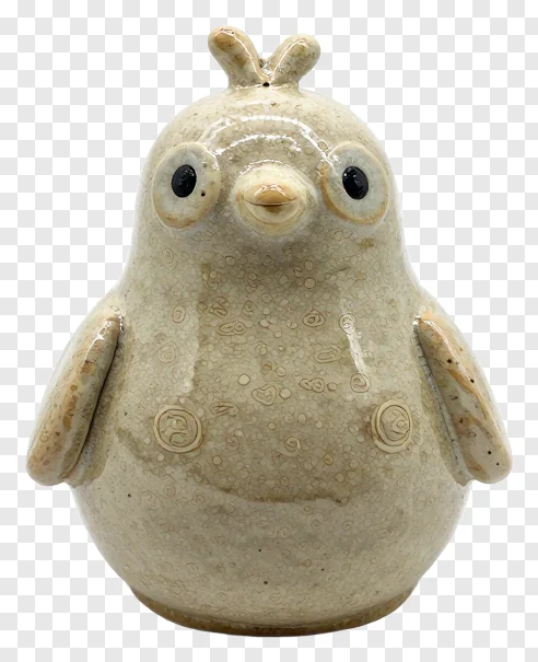 A ceramic bird figurine with speckled glaze and simple features.