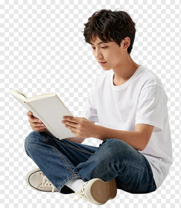 Young student sitting on floor reading book.