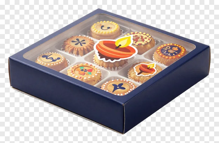 Navy blue box containing patterned Diwali sweets with a diya sticker overlay.