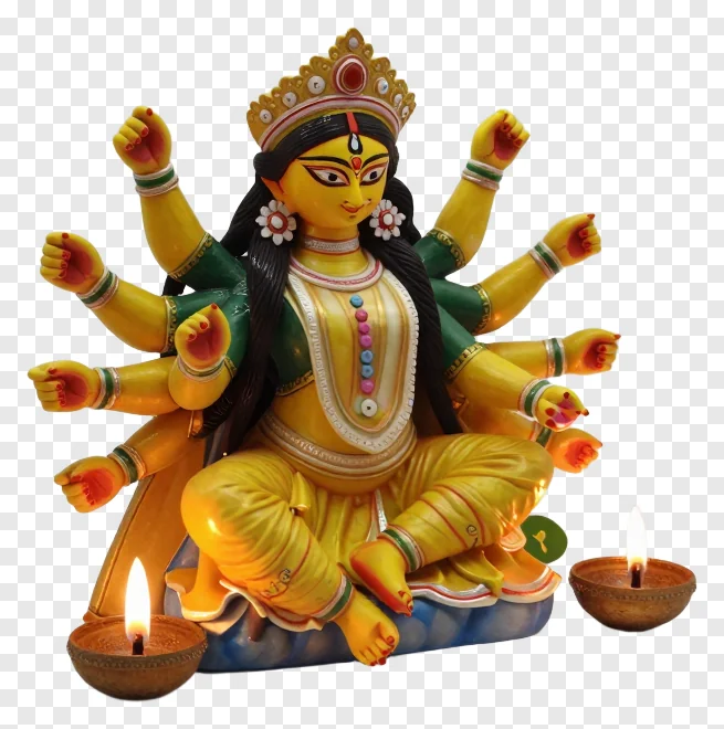 Golden Durga statue with eight arms and two lit diyas.