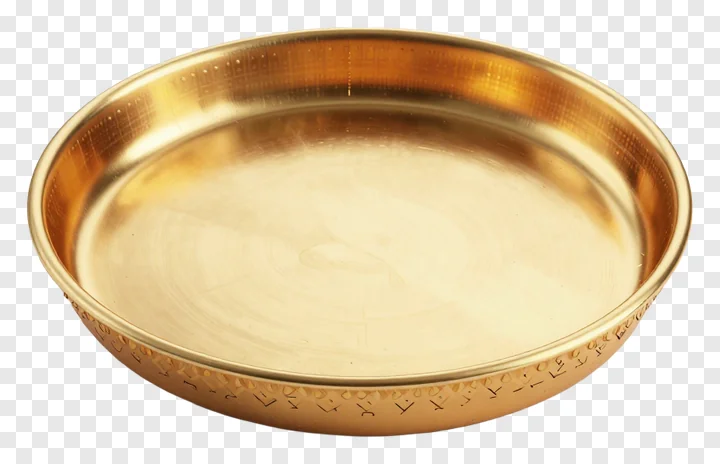 A golden Karwa Chauth pooja thali with an etched border design.