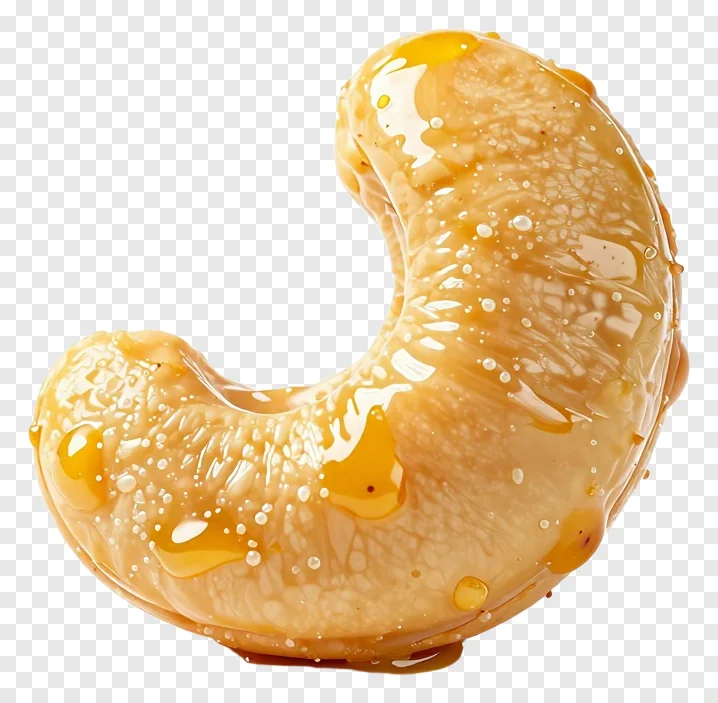 A turmeric glazed cashew nut with a shiny coating.