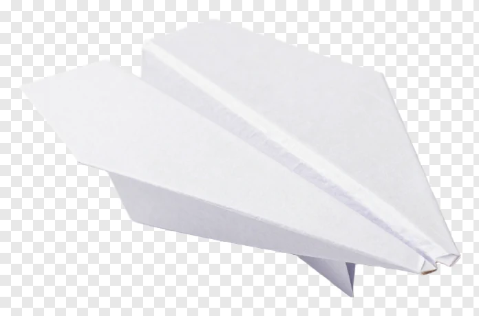 A white paper airplane flying through the air.