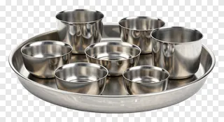 Stainless steel thali set with seven compartments.