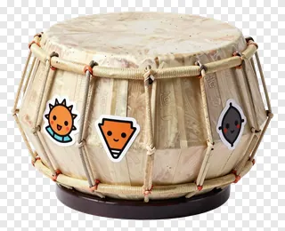 A decorated tabla drum with cartoon stickers.
