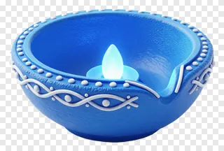 A blue clay diya with white scrollwork and a glowing candle.