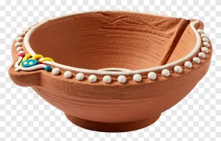 A decorated clay diya with beads and a colorful accent.
