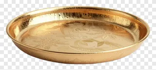 A golden thali with engraved floral patterns.
