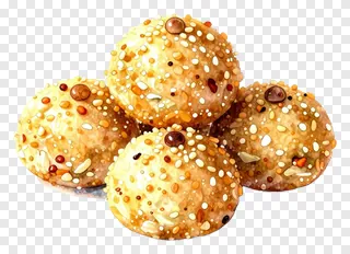 Four round Durga Puja sweets topped with sesame seeds.