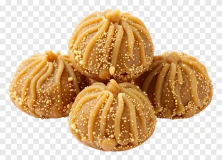 Four Durga Puja sweets with decorative swirls and sprinkles.