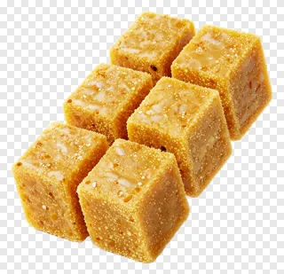 Six golden besan ladoo cubes with floral patterns.