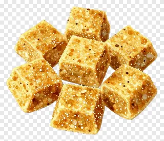 Cluster of golden besan ladoo cubes with speckled texture.