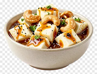 Bowl of makhni paneer with cashews and herbs.