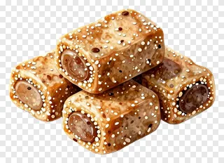 Four stacked kaju katli sweets with nut inclusions.