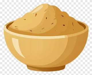 A wooden bowl containing a golden paste.